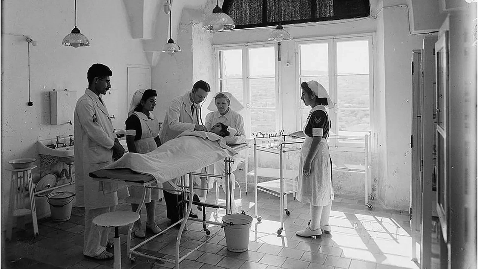 Black and white photo of a surgical team in the early 1900s